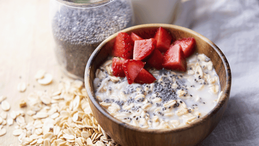 A bowl of overnight oats with chia seeds and strawberries