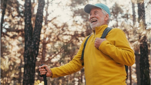 An older adult man is outdoors smiling and enjoying a new experience