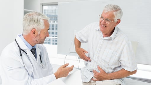 Healthcare provider speaking with an older adult during a wellness consultation about digestive and overall health.